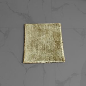 Handmade wool rug sample (1 x 1 foot) showing texture and color