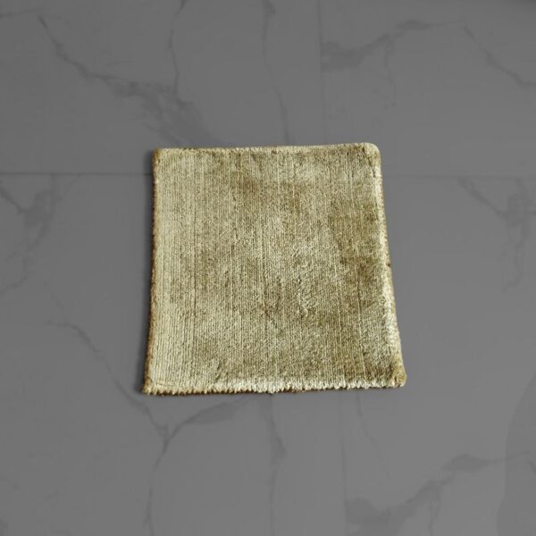 Handmade wool rug sample (1 x 1 foot) showing texture and color